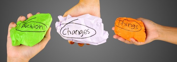 Hands holding crumpled paper with words action changes things