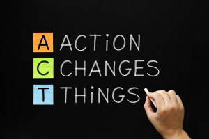 image of hand writing action changes things acronym