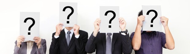 photo of business people with question marks masks covering their faces