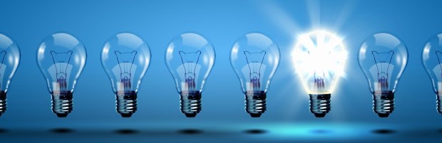 photo of row of light bulbs with one glowing